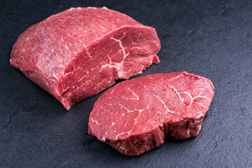 Raw dry aged wagyu beef rump steak slice and piece as close-up on black background with copy space