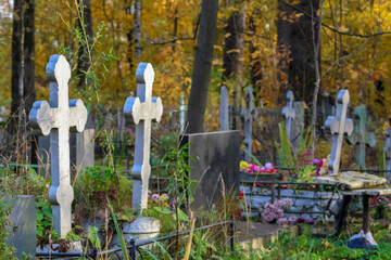 Two silvery grave crosses in the Orthodox Christian cemetery. side view. cloudy autumn day....