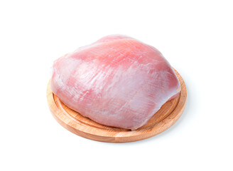 Turkey fillet on a round board on a white background.