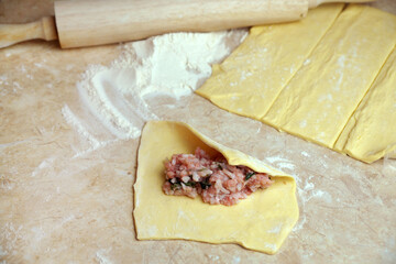 cooking pies, minced meat with rice on rolled dough