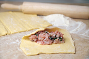 cooking pies, minced meat with rice on rolled dough