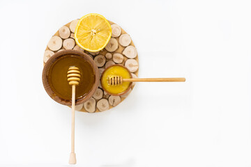 Bowl of honey on white background. Symbol of healthy living and natural medicine. Aromatic and tasty.