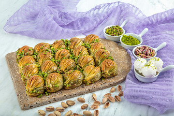 Turkish Midye Baklava ( Mussel Shape Baklava ) with green pistachio Powder and Butter Cream....