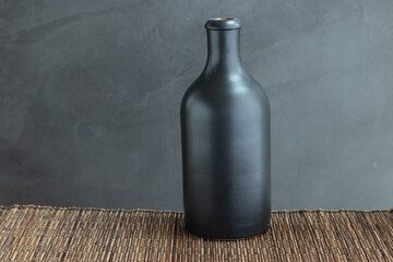 Black bottle on a gray background