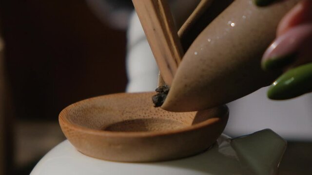 The tea master pours tea from the chahe into the teapot. Slow motion close-up, macro shot. Traditional Chinese tea drinking ceremony. Chinese Japanese tea, Puer Shu Gong Ting Xiao Tocha Oolong Zhang