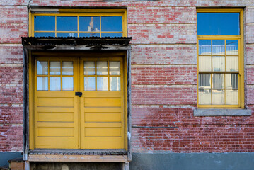 Fototapeta na wymiar Yellow doors, brick building