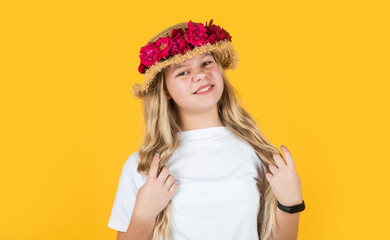 happy child girl in straw hat with rose flowers, fashion