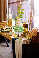 A candy bar with sweets in white and green tones.