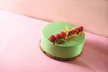 mousse cake with pistachio and raspberry flavor. homemade desserts. gourmet cake with an...