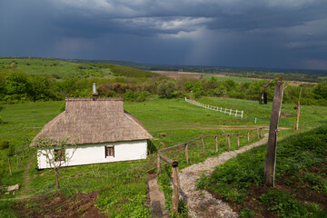Fototapeta na wymiar Ukrainian village against the backdrop of storm clouds