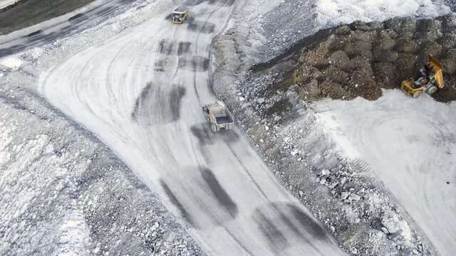Aerial view shot, open pit mine, dumpers, quarrying extractive industry, stripping work. High quality 4k footage