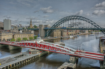 View of Port of Tyne, Bridge Street, Tyne Bridge and Millennium Bridge over river Tyne at Newcastle Quayside on a cloudy day