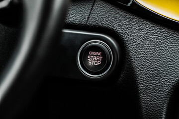 Close up engine car start stop button. Modern car black interior details.