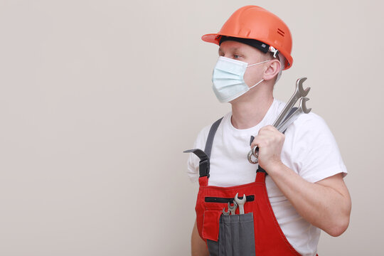 Portrait Engineer Worker Or Mechanic Wearing Helmet And Face Mask For Protect Virus Covid 19 On White Background, With Holding Wrench. Labor Day