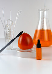 Ripe organic persimmon fruit and persimmon extract in cosmetic bottle with dropper. Abstract chemical or cosmetic laboratory.