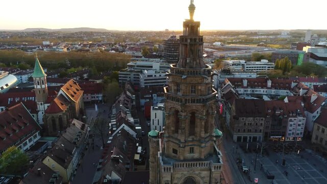 Flight over the beautiful rustic city Weinsberg in Heilbronn district in Germany at the sunset. Old buildings combine with modern architecture, grean areas, parks and railway tracks. Panorama of city.