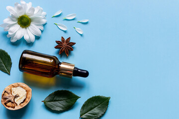perfume bottle, flowers and walnut natural ingredients of natural cosmetics with place for text