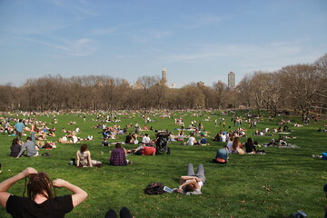 MANHATTAN, NEW YORK - MAY 7, 2014: People hanging out in Central Park on a sunny Sunday.