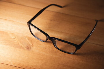 eye glasses on wooden desk