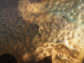 Metal bronze textured plate. Bronze or copper polished surface with dents, scratches and indentations. Metal texture
