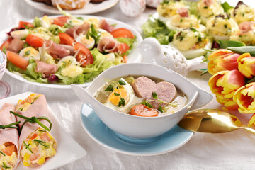 Easter table with traditional white borscht with egg and sausage