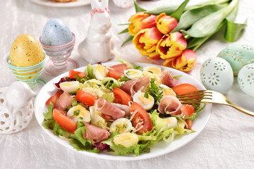 Fresh salad with quail eggs and prosciutto ham for Easter breakfast