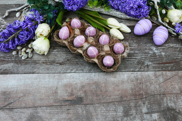 Easter eggs with flowers on wood background