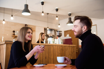 Young couple talking in a coffee shop
