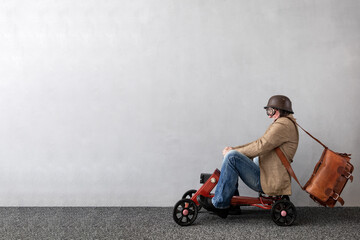 Senior businessman against concrete wall with copy space