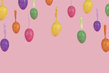 Creative Easter layout made of flying colorful eggs on light pink background