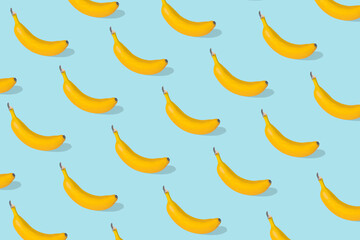 Trendy Summer food pattern made with fresh banana fruit on bright blue background