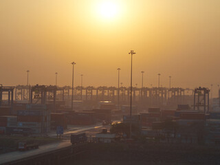 India, Mumbai Port Trust - 25 January, 2017: View to stored container during the morning sunrise.