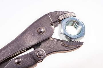 Obraz premium Adjustable wrench with a tightened nut. Accessories for mechanics carrying out repairs in the household.