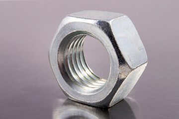 Metal nut with metric thread. Metal accessories for assembling metal parts.