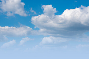 Blue sky background with white dramatic clouds and sunlight, sky background