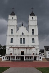 Catholic church stands against a gloomy sky in the Latvian village of Aglona on July 19, 2019