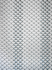 Old metal steel springy mesh with chain link on a beige background