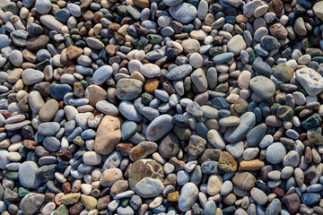 Smooth round pebbles texture background. Pebble sea beach close-up