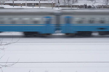 side view on a moving train on railroad tracks. transportation industry in winter season . High quality photo
