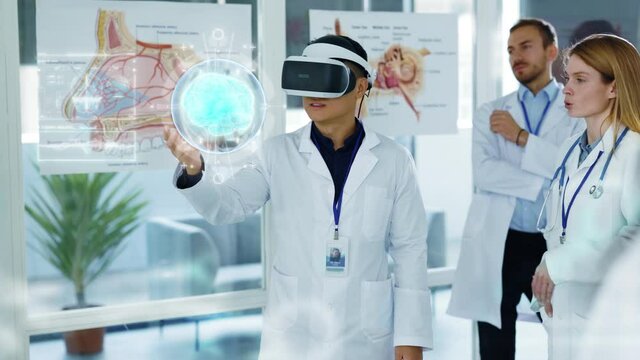 Future Medicine. Doctors discussing Human Brain Surgery wearing Virtual Reality Glasses. High Tech Technologically. Brain Scan Tomography. Technologically Hospital. Artificial Intelligence