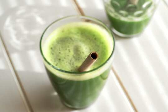 Bamboo straw sticking out or a glass of green juice - zero-waste lifestyle