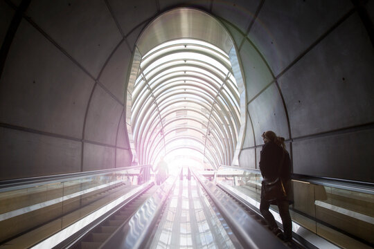 Rear view of woman ascending subway staircase in tunnel, Bilbao, Spain