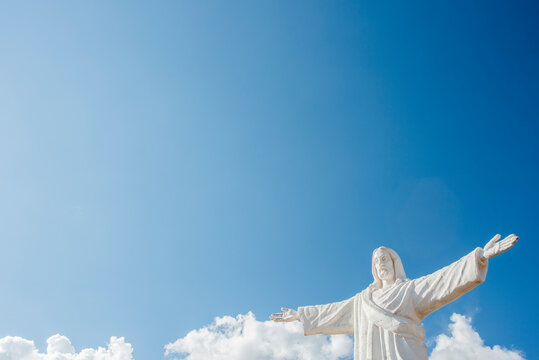 Statue of Christ against blue sky at Sacsayhuaman in Cusco, Peru