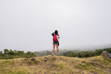 Hiker on edge of mountain top, Haleakala National Park, Maui, Hawaii