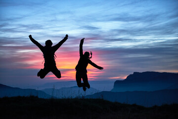 Hikers jumping for joy, Manigod, Rhone-Alpes, France