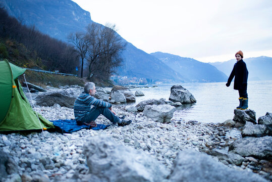 Father and son camping by lakeside, Onno, Lombardy, Italy