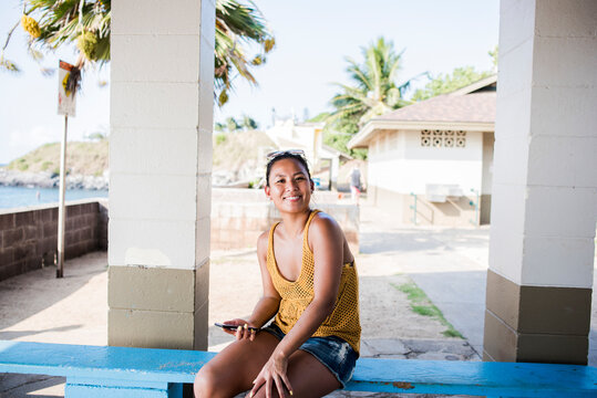 Woman sitting on bench, Hookipa Beach, Maui, Hawaii