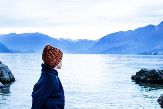 Boy looking out to lake, Onno, Lombardy, Italy