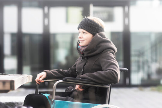 Woman in wheelchair in street