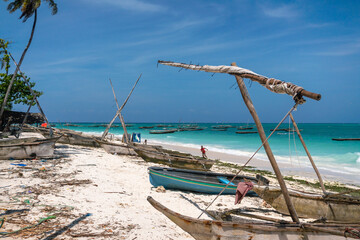 Fototapeta na wymiar Traditional wooden dhow boats on the White Sand Beach with amazing turquoise water in the Indian ocean at Nungwi village, Zanzibar, Tanzania
